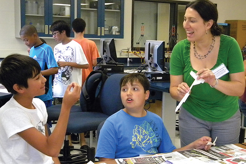 A professor teaching young students.