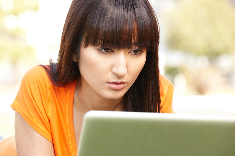 A woman looking at a computer