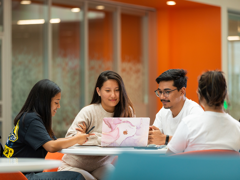 Students sitting with laptop