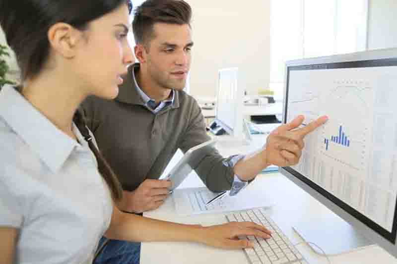 Two people using computer