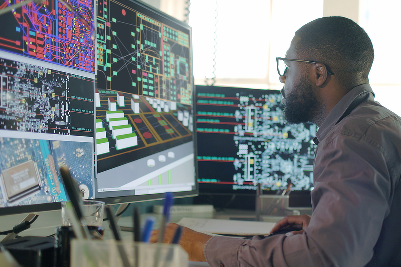 Man at computer screens