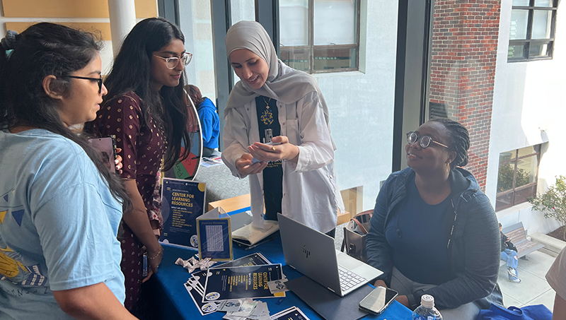Amina Almoustafa ’24 M.S. (center) with her fellow Chargers on campus.