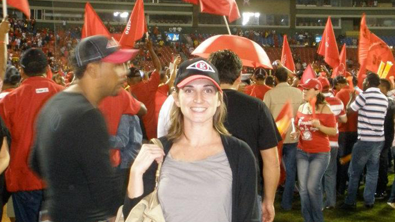April Yoder, Ph.D., celebrating with fans on the baseball field.