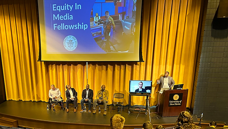Prof. Wayne Edwards (at podium) and panelists at the event.