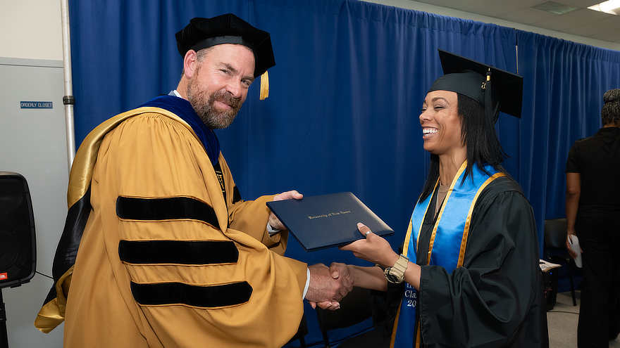 Jens Frederiksen giving student diploma
