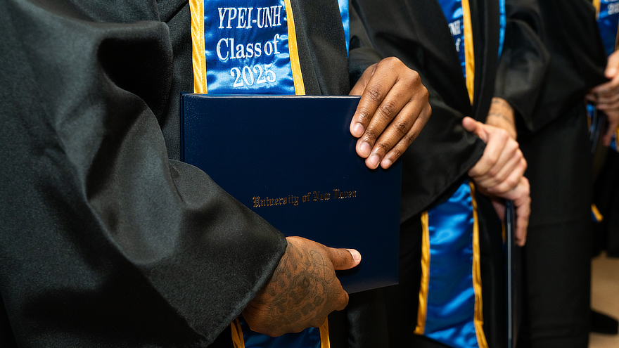 Graduate holding diploma