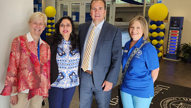 Ranjana Maitra /U+0026#x27;91 MBA and her fellow University staff members. Left to right: Cindy Gallatin, Ranjana Maitra, interim president Dr. Sheahon Zenger, and Anne Whitman.