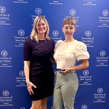 Courtney McNelis, /U+0026#x27;23 (right) receiving the Outstanding Achievement Award in Human Resource Management 2023 next to Jan Louise Jones, Ph.D. (left)