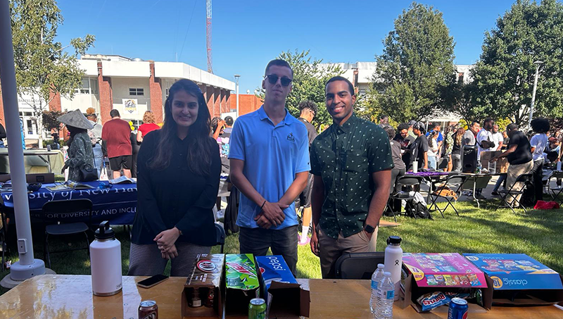 Jalak Popat ’24 M.S. at the University’s Involvement Fair (left) with Christopher O/U+0026#x27;Connor ’24 and Christian Rosario ’24.