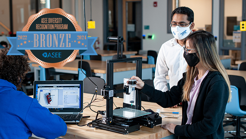Engineering students working at a station.