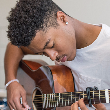 A student playing guitar