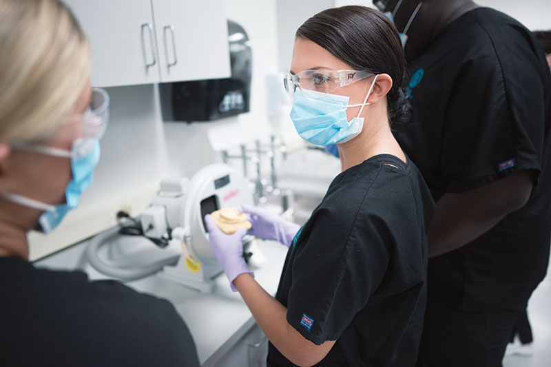 A student wearing a mask and goggles