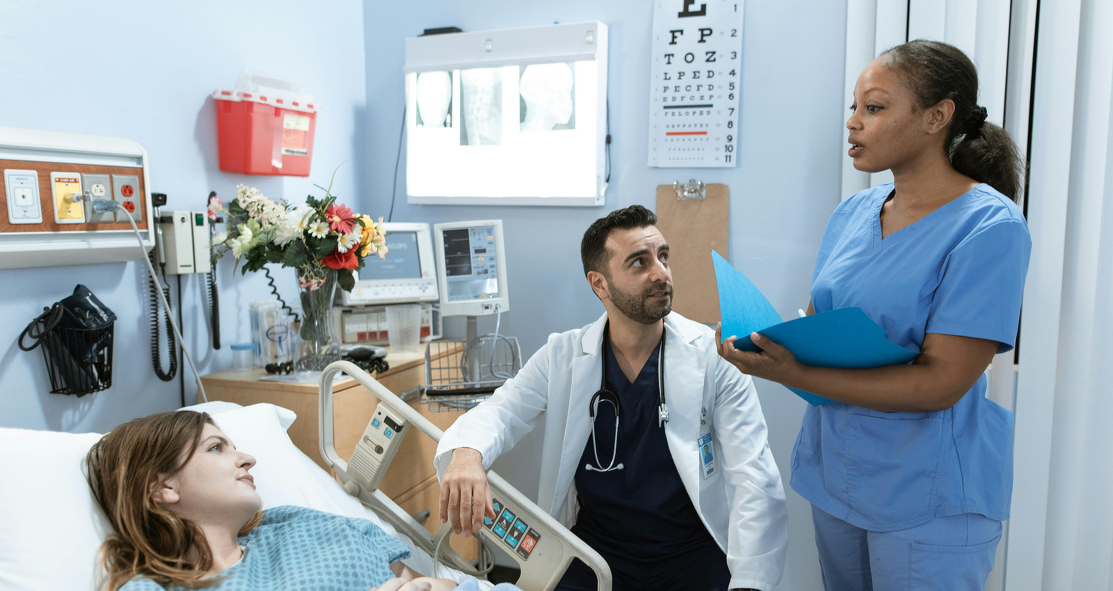 Two medical professionals discuss a patient's case.