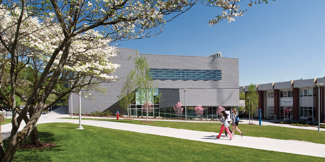 Students walking through the Maxcy Quad with Gehring Hall in the background.