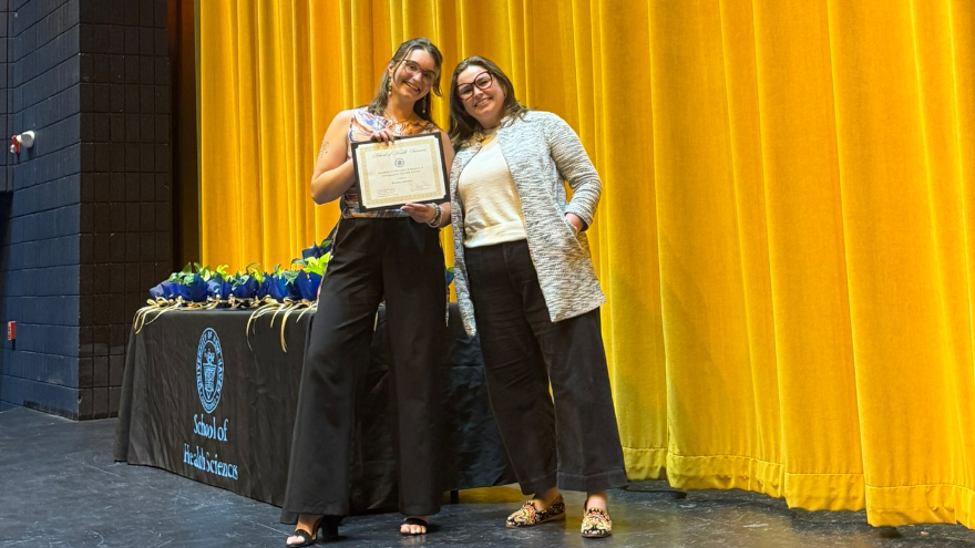 Beatrice Glaviano poses on stage with her award.