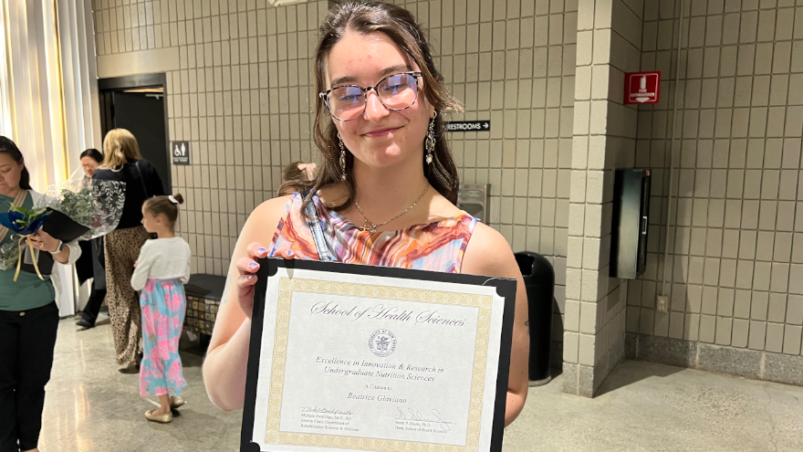 Beatrice Glaviano showing her award.