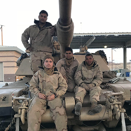 Andrew Ghataora /U+0026#x27;24 (front) with his fellow crewmembers after his first training exercise as a tank commander. 
