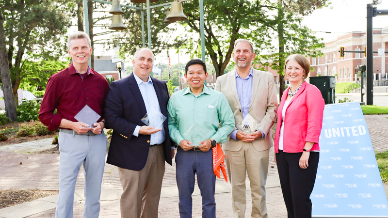 Greg Overend (second from right) and fellow honorees at the LIVE UNITED award ceremony. Everyone is standing outside, in a line, and smiling.