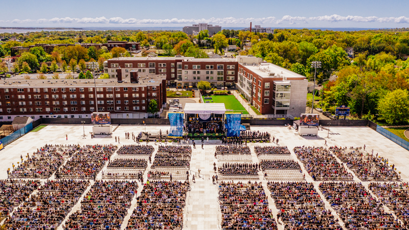 Aerial shot of a previous commencement showcasing thousands of students and guests gathered for graduation.
