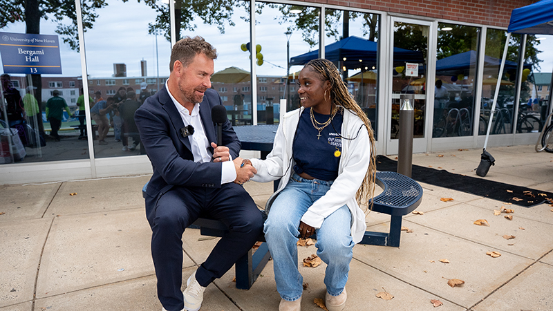 President Jens Frederiksen, Ph.D., chats with a new Charger during move-in day