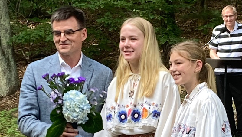 Bradley Woodworth, Ph.D. with two women dressed in the Estonian national costumes.
