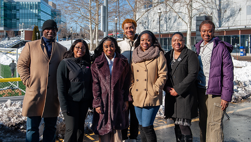 Group Image of Jamaal Bowman ’99 (left), Ariana Eastwood ’23 (third from right), and Dr. Ophelie Rowe-Allen (second from right) with students at the event.