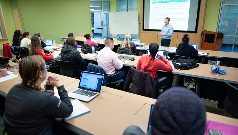 Image of Karl Minges, Ph.D., MPH, leading a classroom discussion before the pandemic