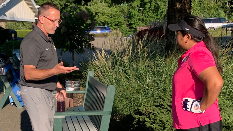 Hannah Catallo-Stooks ’24 M.S. and Coach Matt Ward talking.