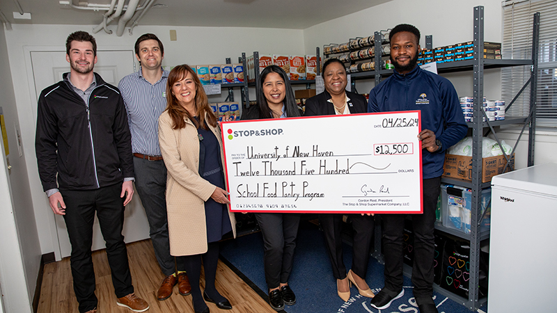 Chargers and representatives from Stop /U+0026 Shop celebrated five years of partnering together to support the Campus Pantry.