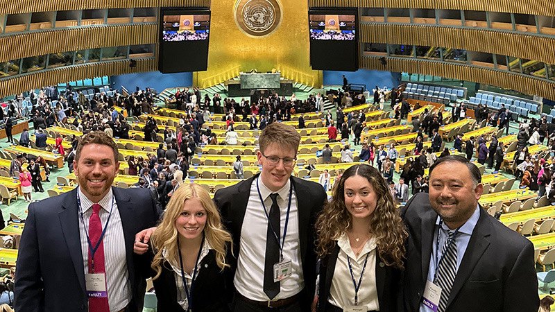 Dr. Chris Haynes (right) with students at the conference.