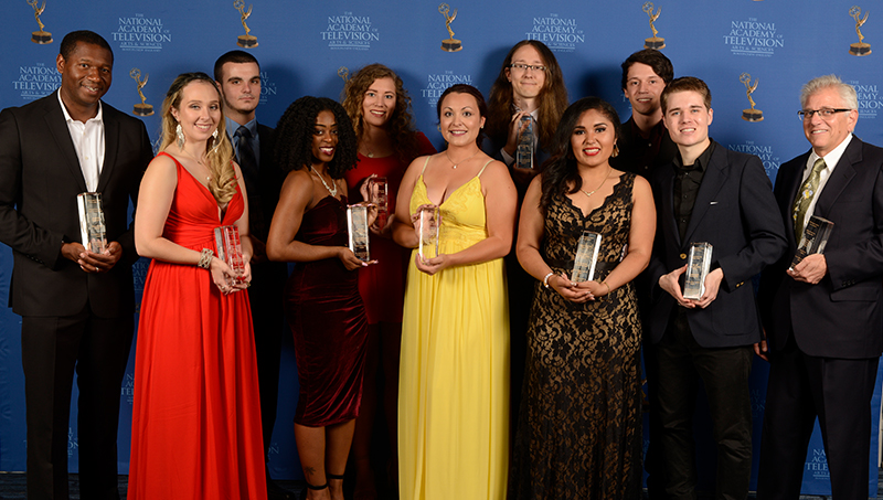students holding awards