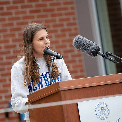 Student speaking at a podium