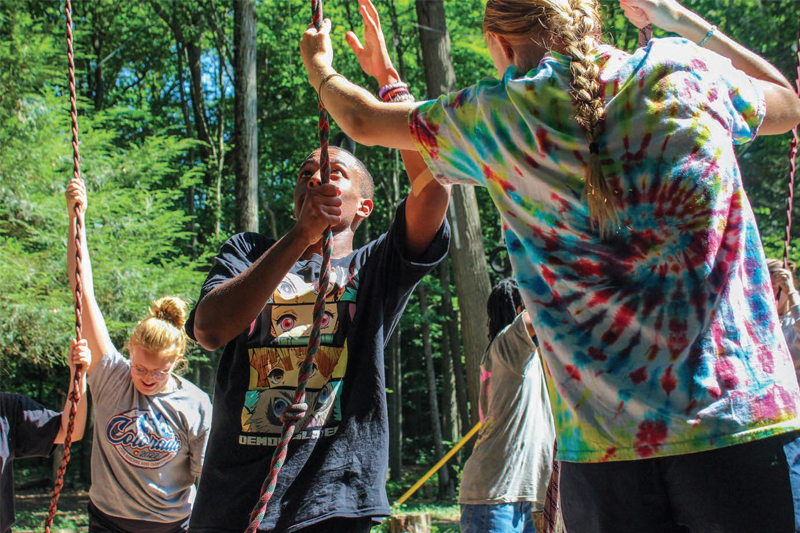 Students climbing ropes