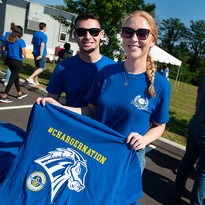 Woman holding ChargerNation t-shirt