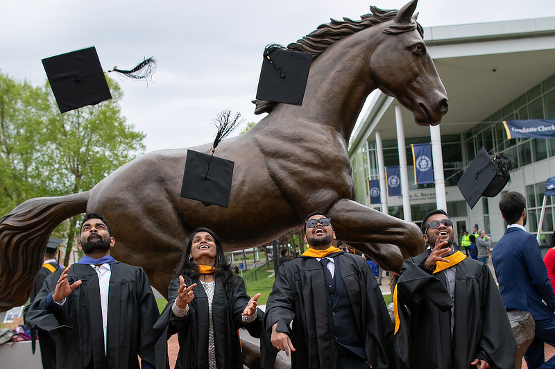 Graduates at Charger statue