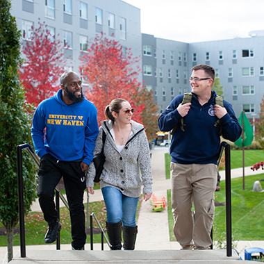 Three veteran students walk on campus